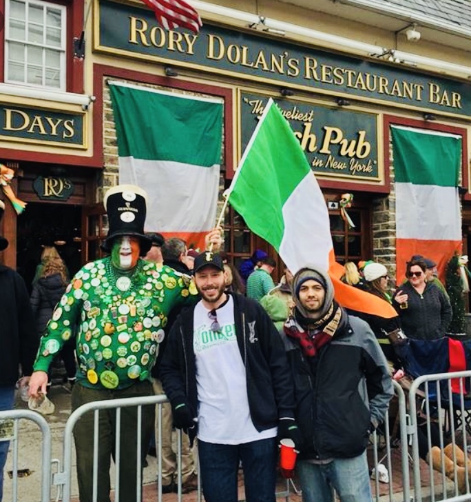 people gathered outside the building with irish flag