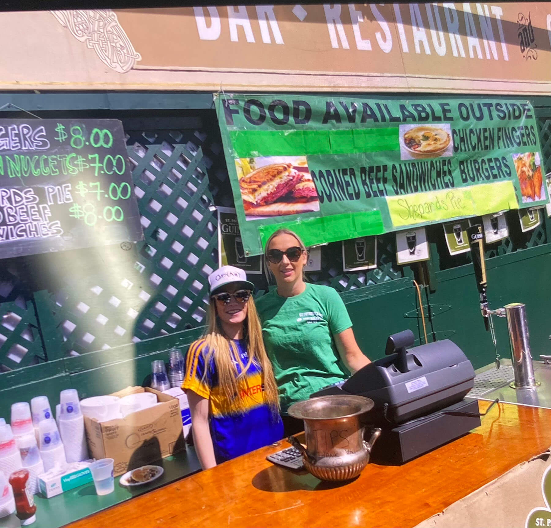 staff dressed in green hats