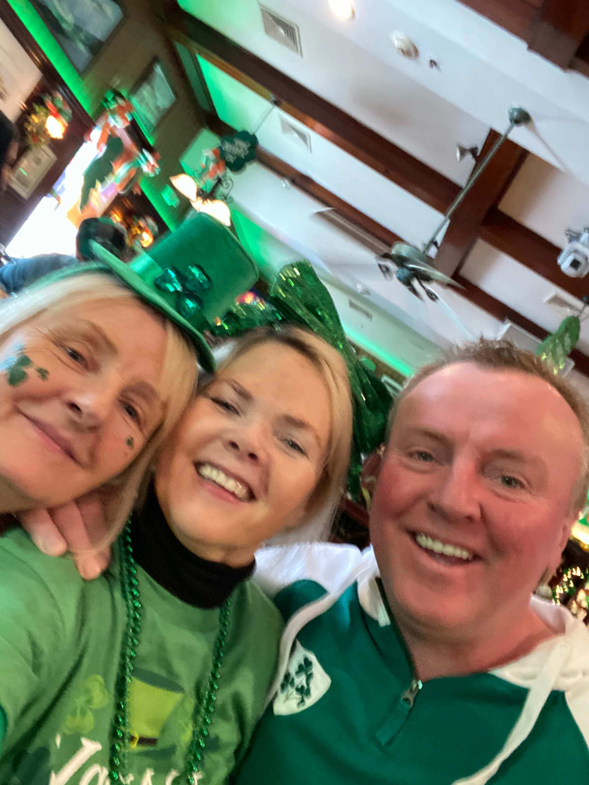 staff dressed in green hats